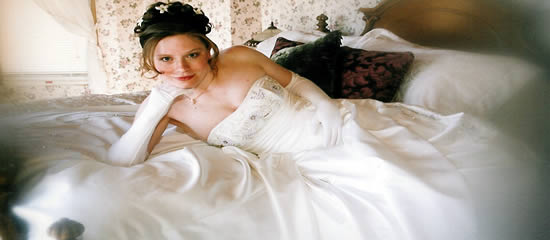 Bride on bed for all inclusive wedding.